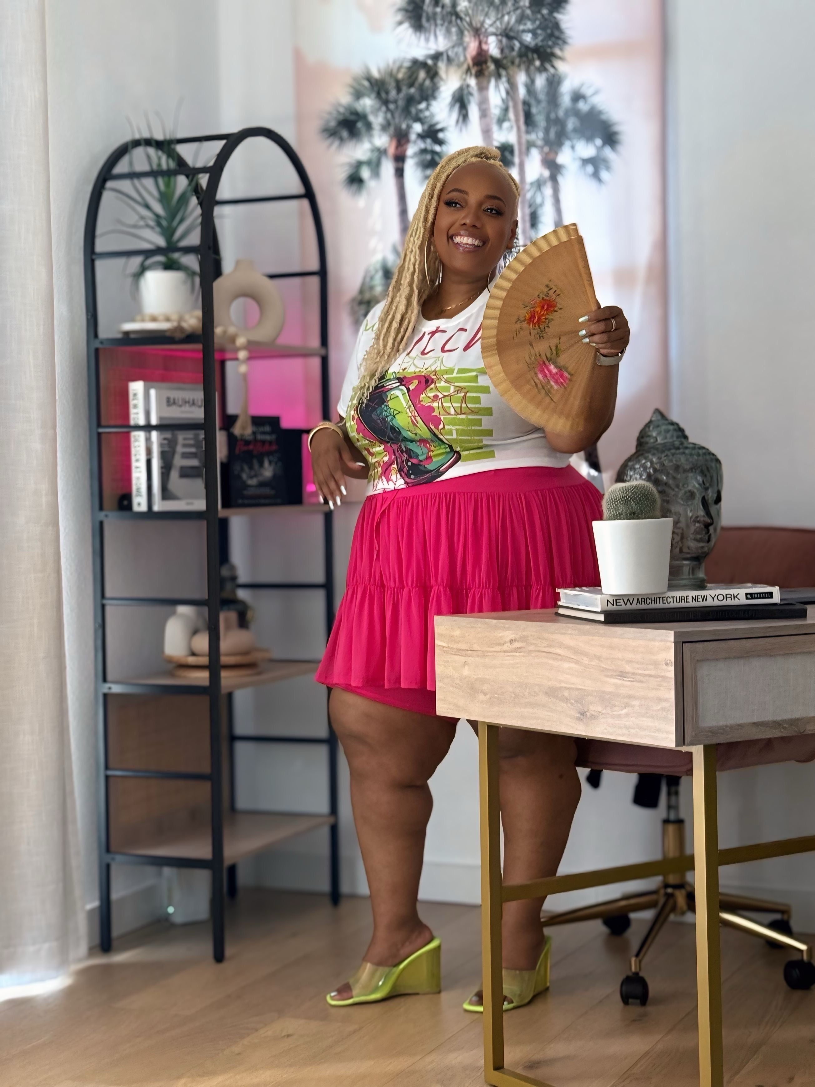 Woman holding a decorative plate in a home office setting